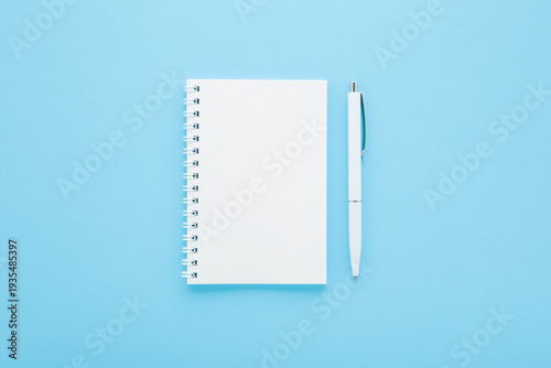 Εκτύπωση καμβά White pen and copybook on light blue table background