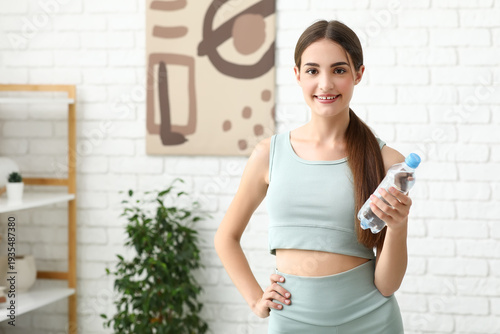 Sporty young woman with bot...