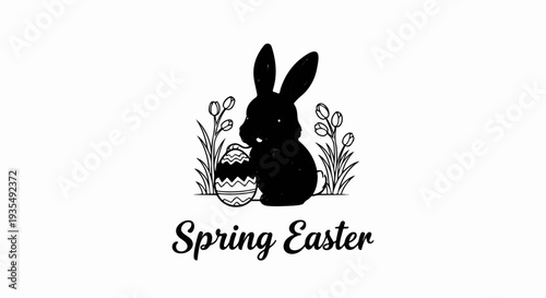 A black silhouette of a rabbit sits with an Easter egg and tulips