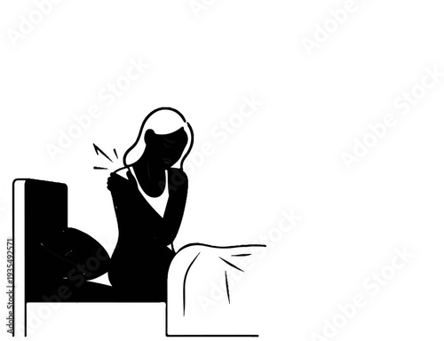 Woman sitting in bed holding shoulder in pain