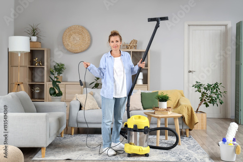 Mature woman with vacuum cl...