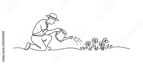 Gardener watering young plants in open field.