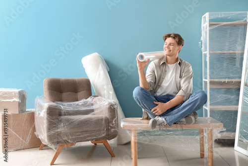 Young man with roll of stre...