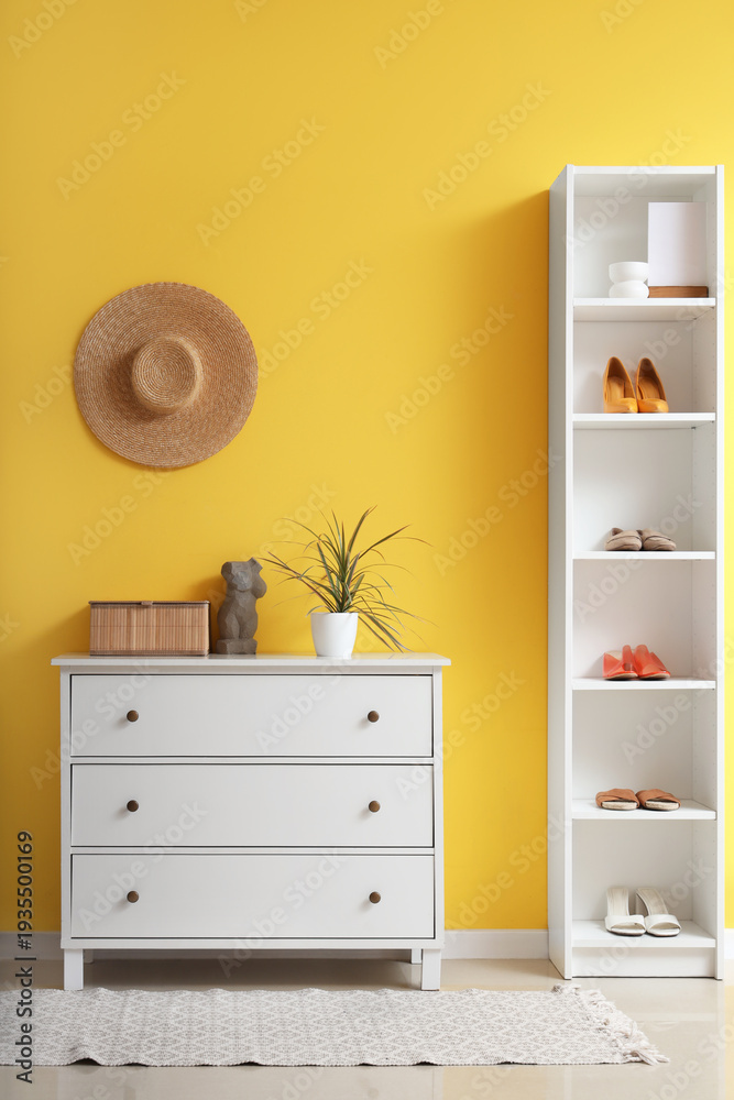 Fototapeta premium Interior of hall with commode and shelf unit
