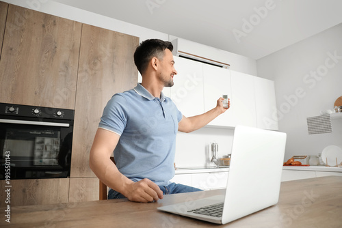 Handsome man with laptop tu...