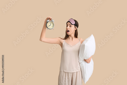 Young woman in pajamas with...