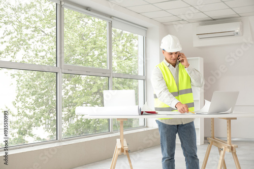 Male contractor talking by ...