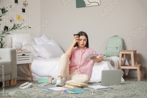 Tired female student with c...