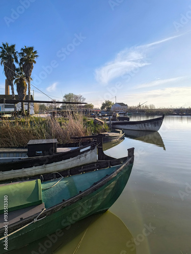 Classic wooden fishing boats anchored on the waters of the Albufera of Valencia
