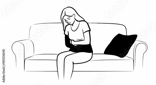 A person clutches their stomach while sitting on a couch