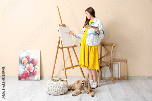 Young pregnant artist with ...