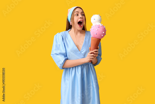 Surprised young woman holdi...