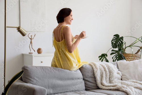 Young pretty woman with cup...