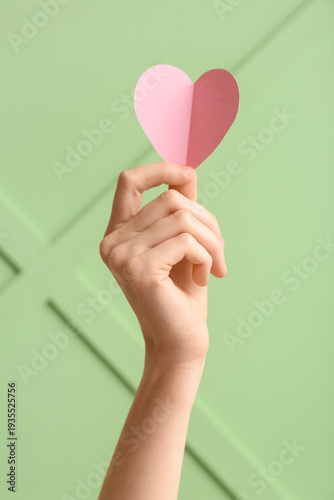 Female hand with pink paper...