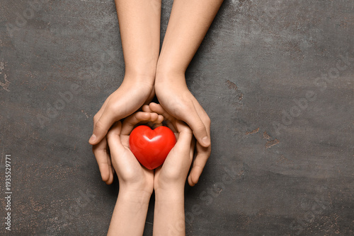 Hands of woman and child wi...