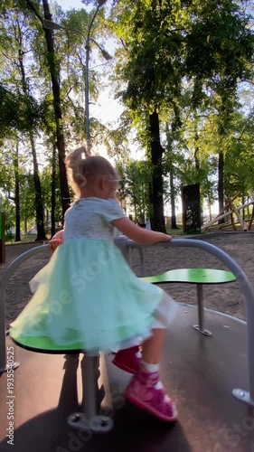 girls ride the carousel in the park