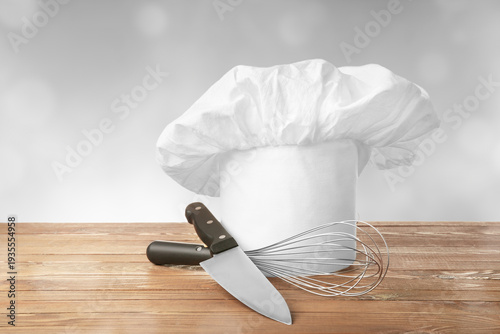 Chef's hat and utensils on ...