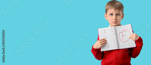 Little boy holding notebook...