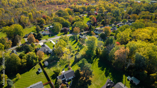 Obraz na plátně Aerial drone view of typical suburban neighborhood with houses, roads and autumn