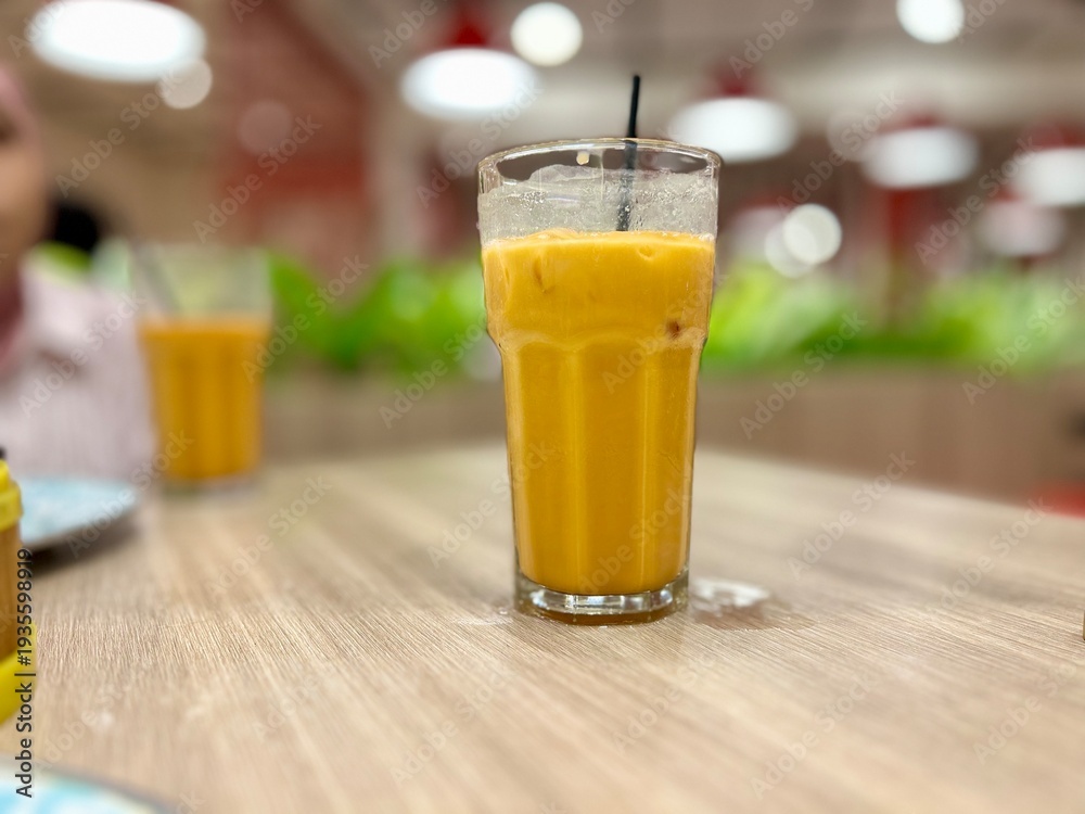 Fototapeta premium glass of thai tea on the table