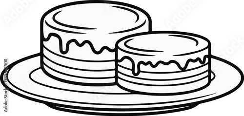 Two layered cakes with icing drips on a plate