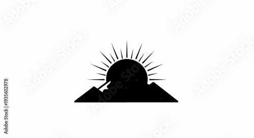 Silhouette of a sun rising over mountain peaks