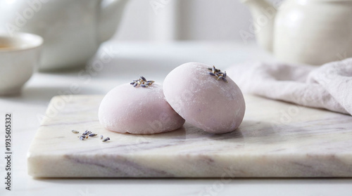Lavender-Flavored Mochi Garnished with Dried Lavender on a Marble Slab Against a Soft, Minimalist Background