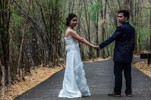asia marry wed on road in bamboo forest