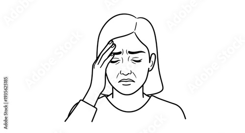 Woman suffering from headache holding hand to her forehead