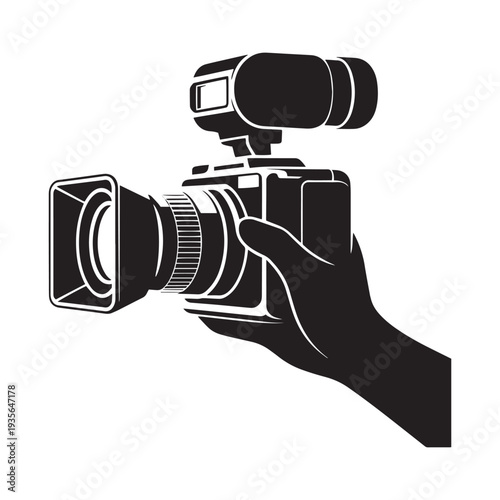 Hand holding a professional black video camera with attached flash or light source for photography or videography isolated on white background