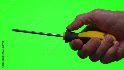 A metal screwdriver in a hand against an isolated background.
A close-up of a construction tool.
A device for driving screws and self-tapping screws.