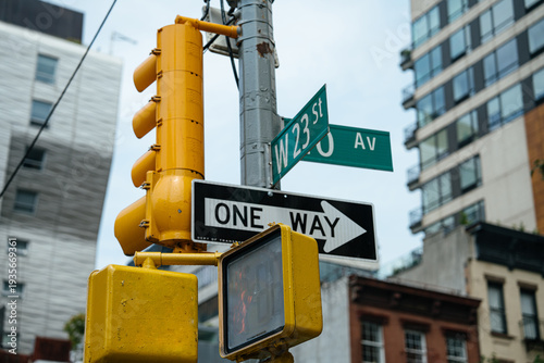 Fotografia Street signs for West 23 Street and 10 Avenue are displayed above a one way traffic sign in New York City