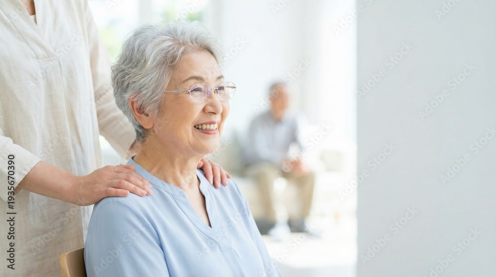 Obraz premium Smiling elderly woman receiving gentle shoulder massage from caregiver in bright home setting, warm affectionate moment conveying comfort and companionship