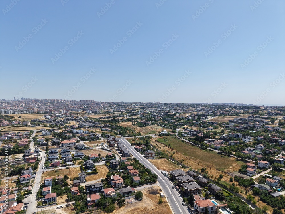 Fototapeta premium Aerial Panoramic View of Coastal Residential Neighborhood and Blue Sea Horizon