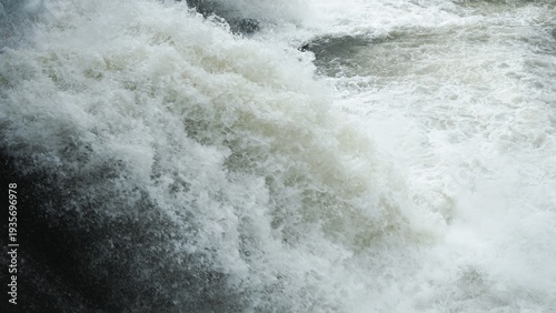 Canvas Print Close-up of rushing white water foam and turbulent river bubbles.