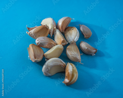Fresh Garlic Cloves on a Blue Background