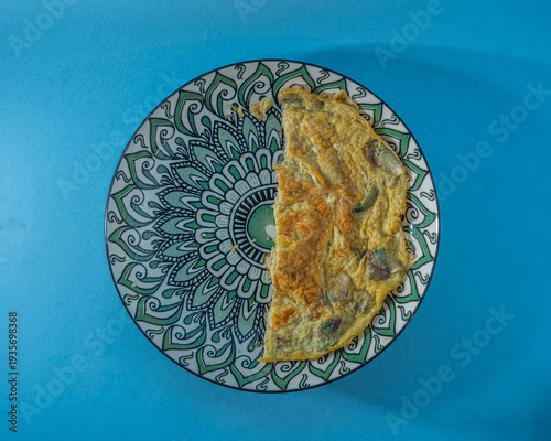 Half-eaten Omelet on Decorative Plate