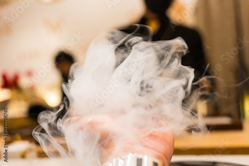 Wallpaper Mural A single piece of sushi resting delicately on the palm and cover with bubbles at a Japanese restaurant. Torontodigital.ca