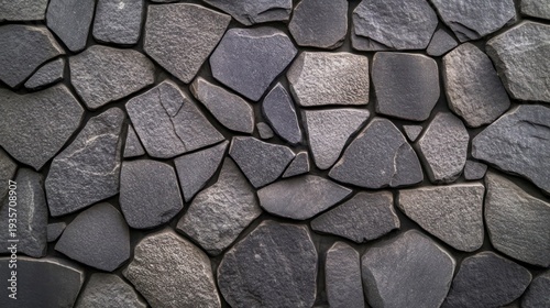 Close-up view of a wall made of irregularly shaped, gray stones