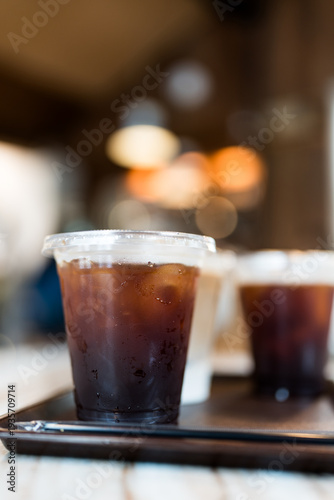 Wallpaper Mural Glass of iced americano coffee with ice cubes served on wood tray Torontodigital.ca