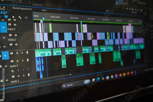 Professional video editing software interface showing complex timeline with video tracks and audio waveforms on computer screen.