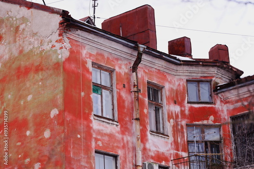 A tall red building with a clock on top, suitable for illustrations about cities or landmarks