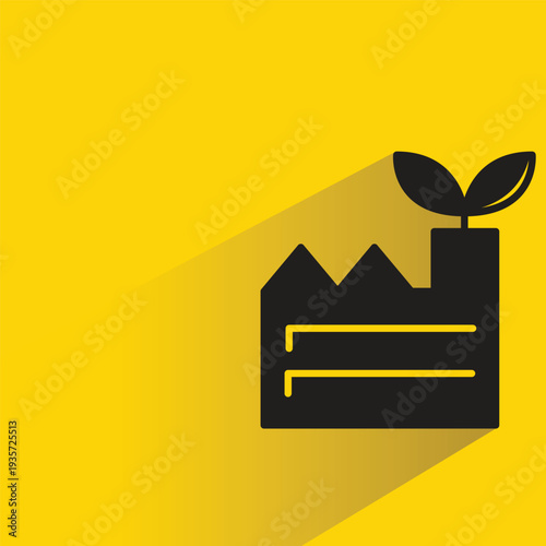 green factory icon with shadow on yellow background