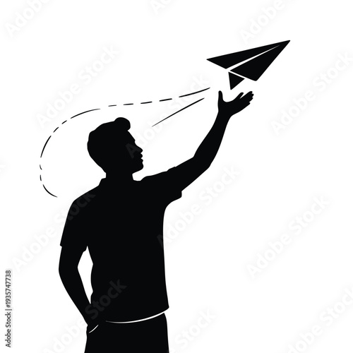 Silhouette of a person launching a paper airplane into the air