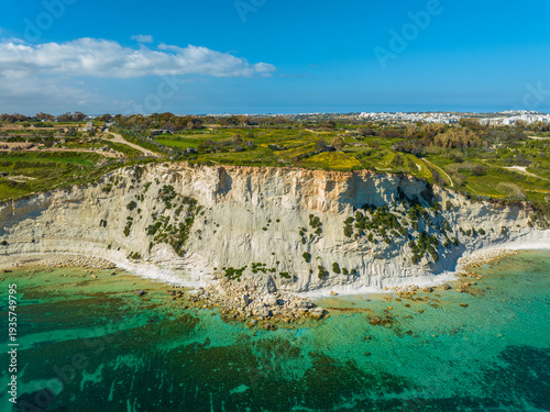Drone view of Maltese countryside, green fields, hills, sea. South part of Malta