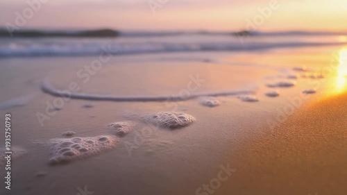 Ocean Wave Foam Gently Washing Shoreline at Golden Sunset