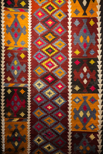 Wallpaper Mural Vibrant kilim rug featuring repeating geometric and tribal motifs in warm reds, yellows and blues. Handwoven wool textile ideal for bohemian, ethnic or traditional interior decor and wall hanging Torontodigital.ca