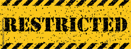 A weathered yellow and black striped warning sign clearly indicates the word RESTRICTED area