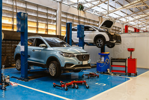 Cars on Hydraulic Lifts Inside Modern Auto Repair Service Garage