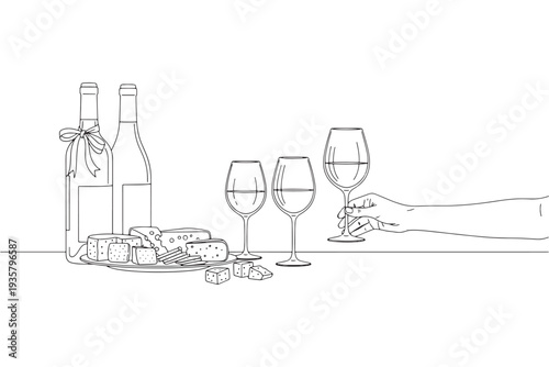 A hand holding a wine glass next to a bottle and cheese plate